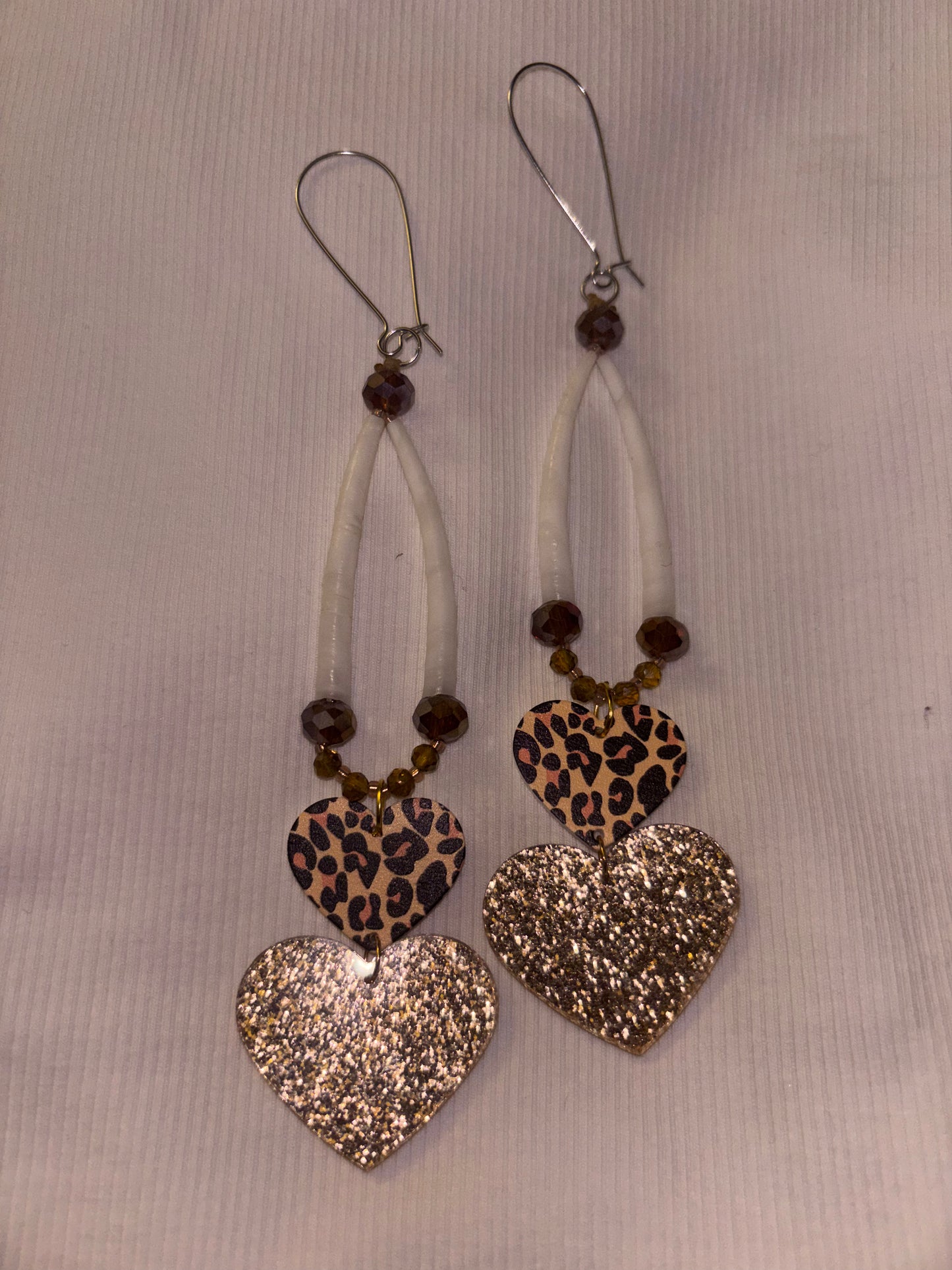 Brown and gold dentalium earrings with cheetah heart attachments