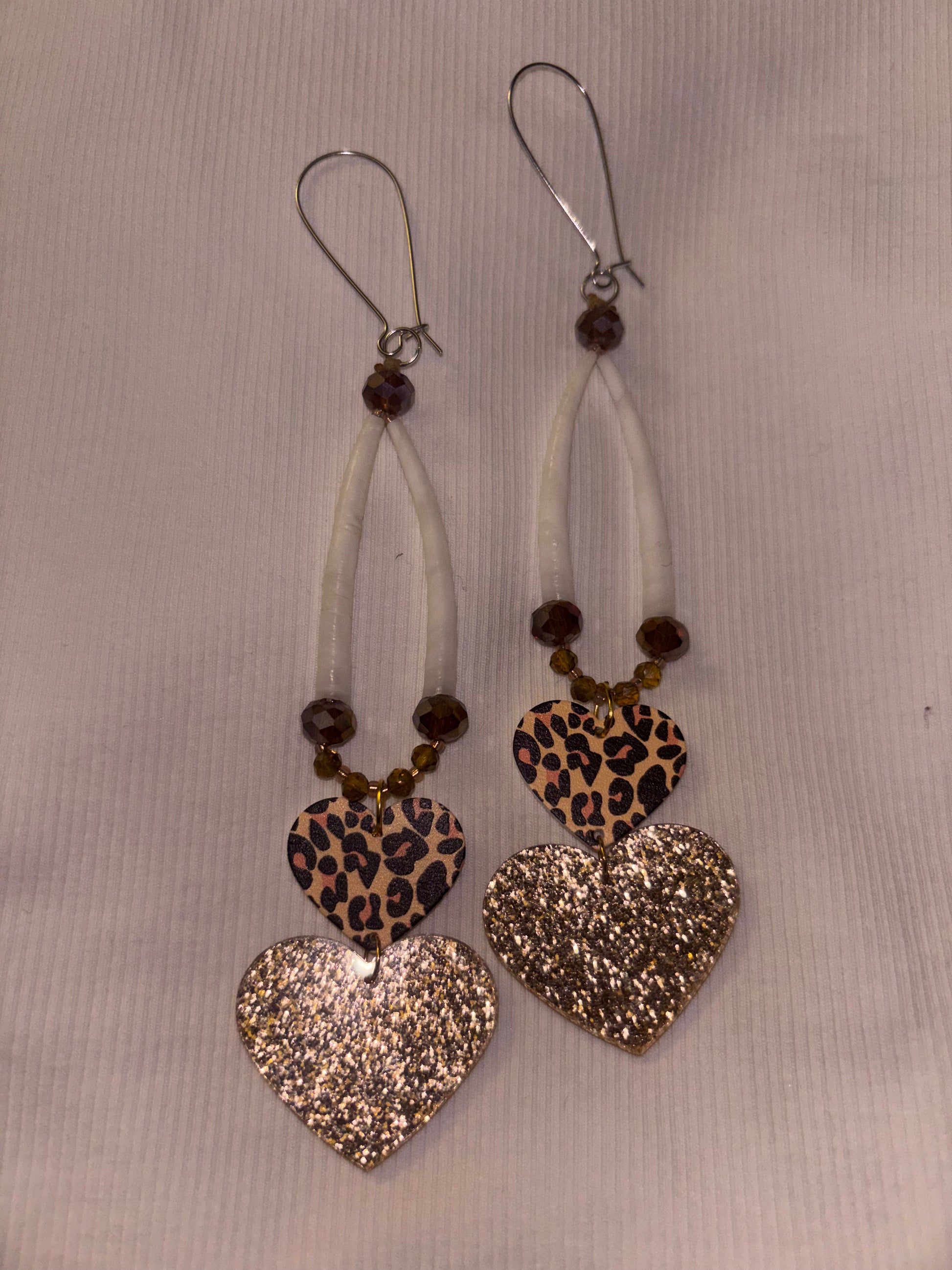 Brown and gold dentalium earrings with cheetah heart attachments