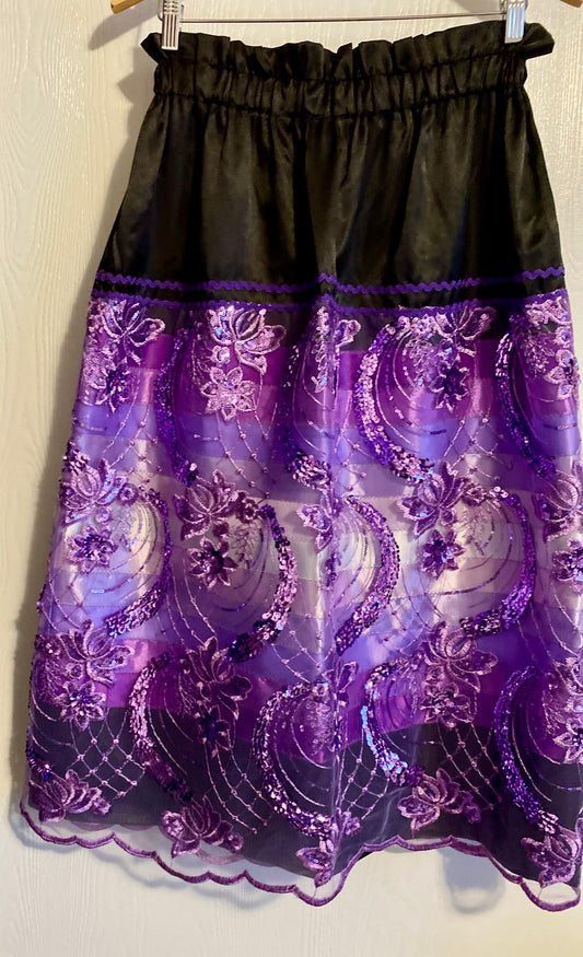 Black skirt with purple lace details on a white background with purple ribbons. Purple ribbon skirt 